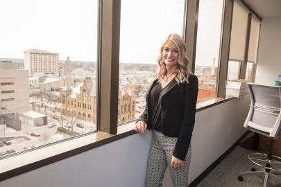 Female student posing in business setting.